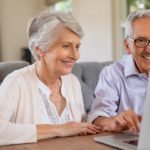 Senior couple using laptop