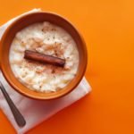 Mungunzá,With,Cinnamon,In,Brown,Porcelain,Pot,And,Orange,Background