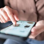 Woman online shopping on smart phone fashion clothes at home